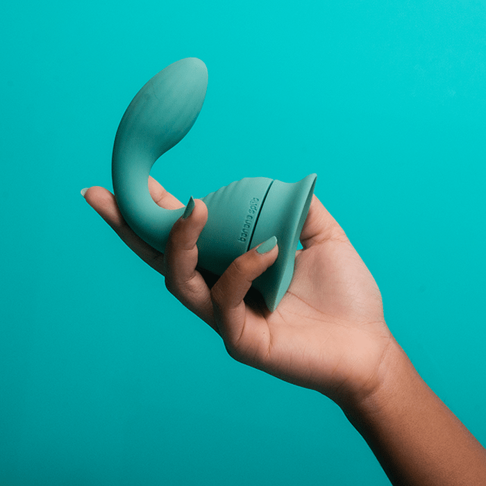 The Dollop held in hand, showing the flared suction-cup base